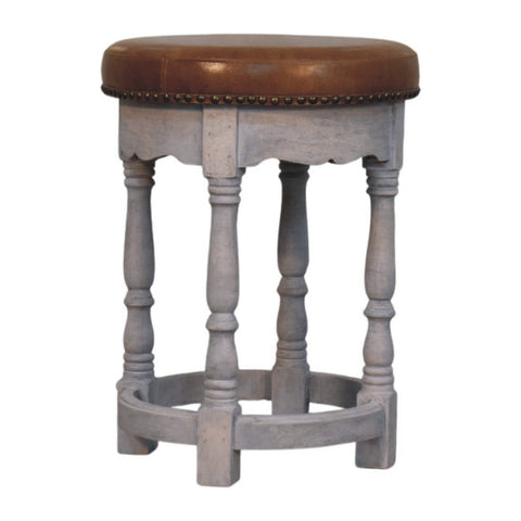 Rustic charm stool featuring a gray wooden frame with a brown leather seat and brass nailhead trim