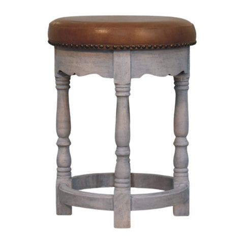 Rustic charm stool with a gray wooden frame brown leather seat and brass nailhead trim for a cozy vibe
