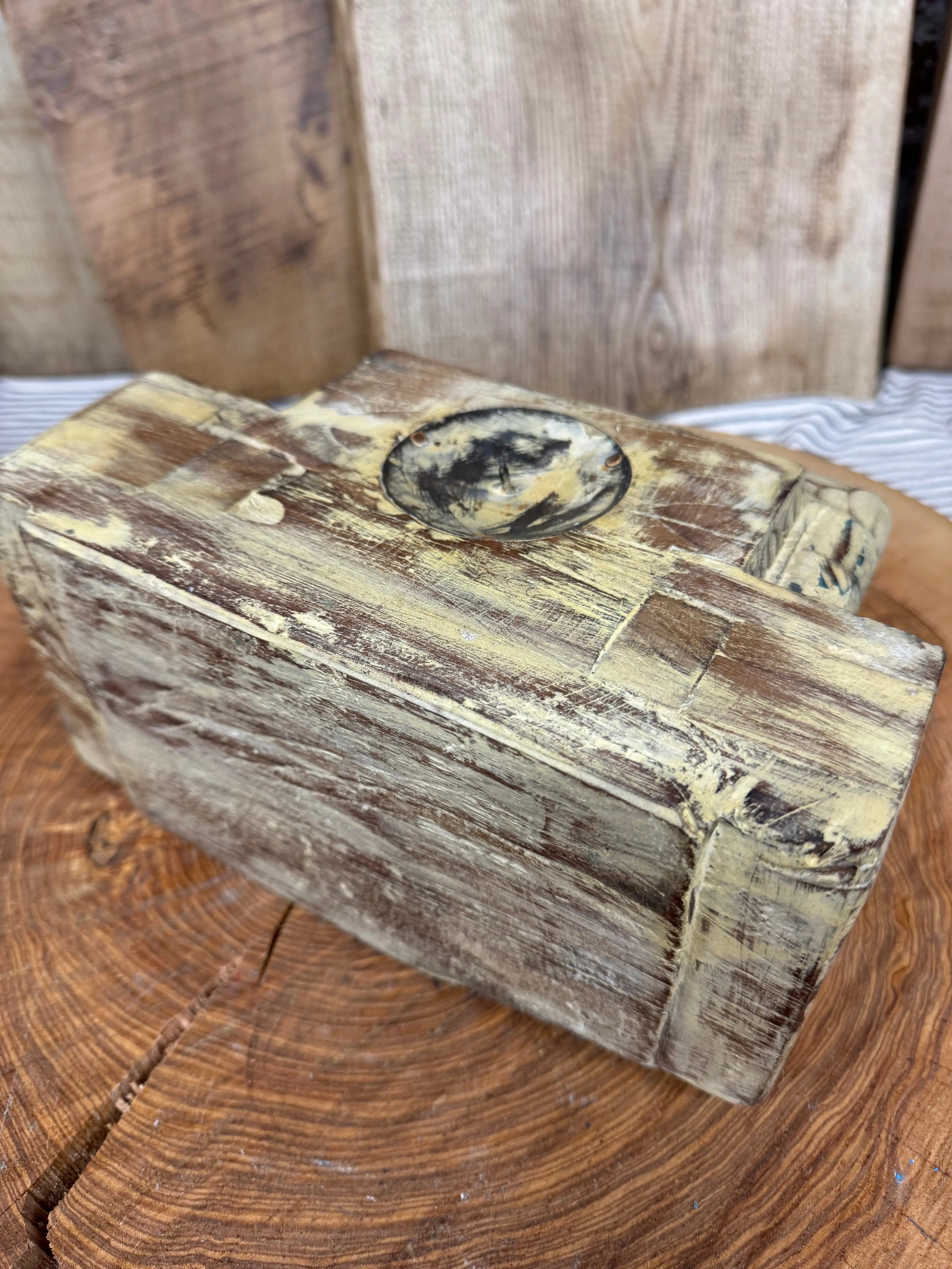 Weathered wooden rustic church candle holder with a darkened circular inset indian pillar base in cream color