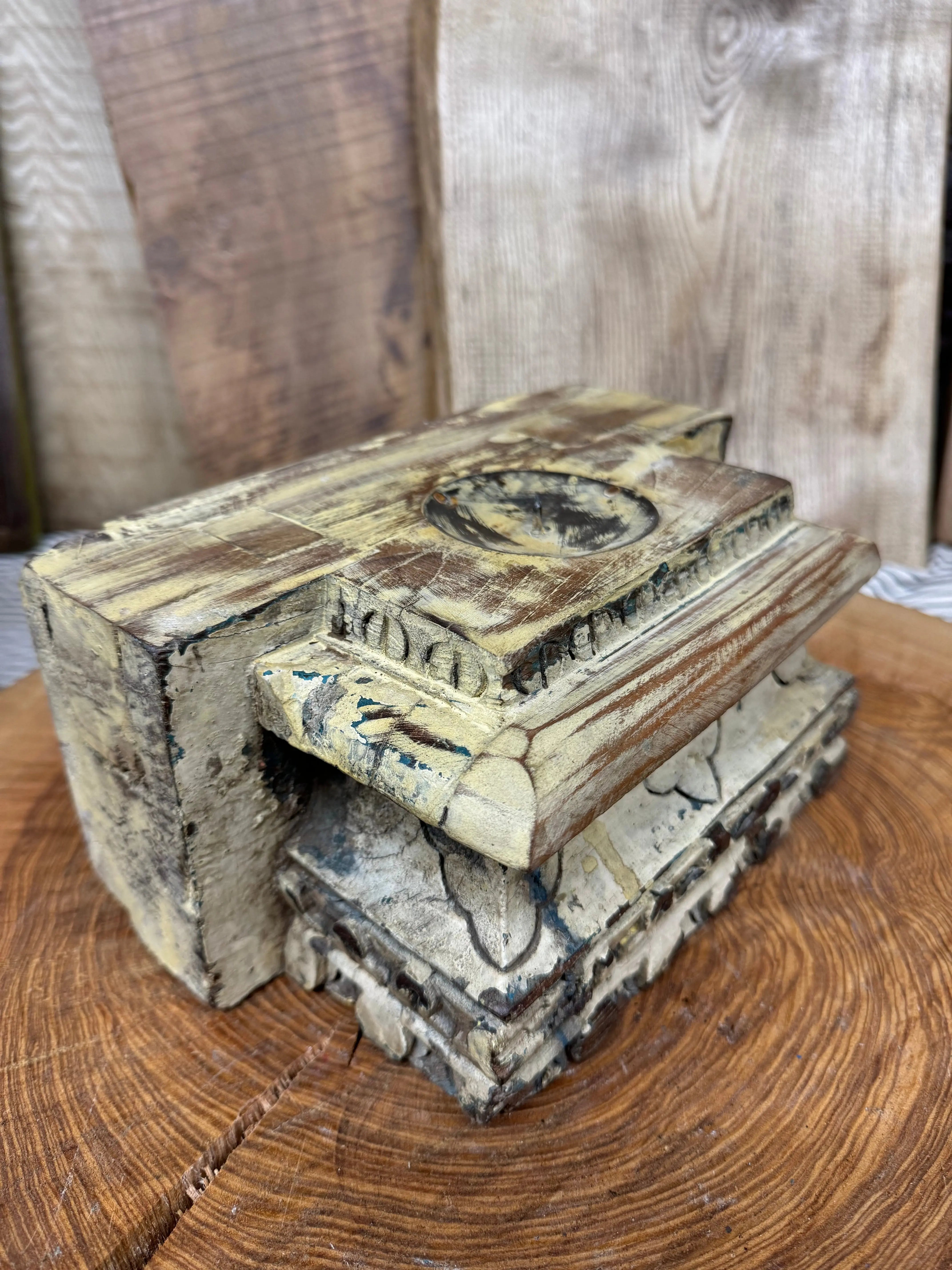 Rustic church candle holder made of weathered cream and brown wood with intricate floral carvings indian pillar base