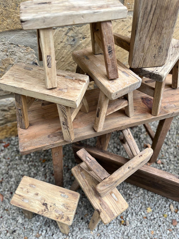 Rustic elm bench with natural grain rustic wooden stools in weathered finish for cozy seating