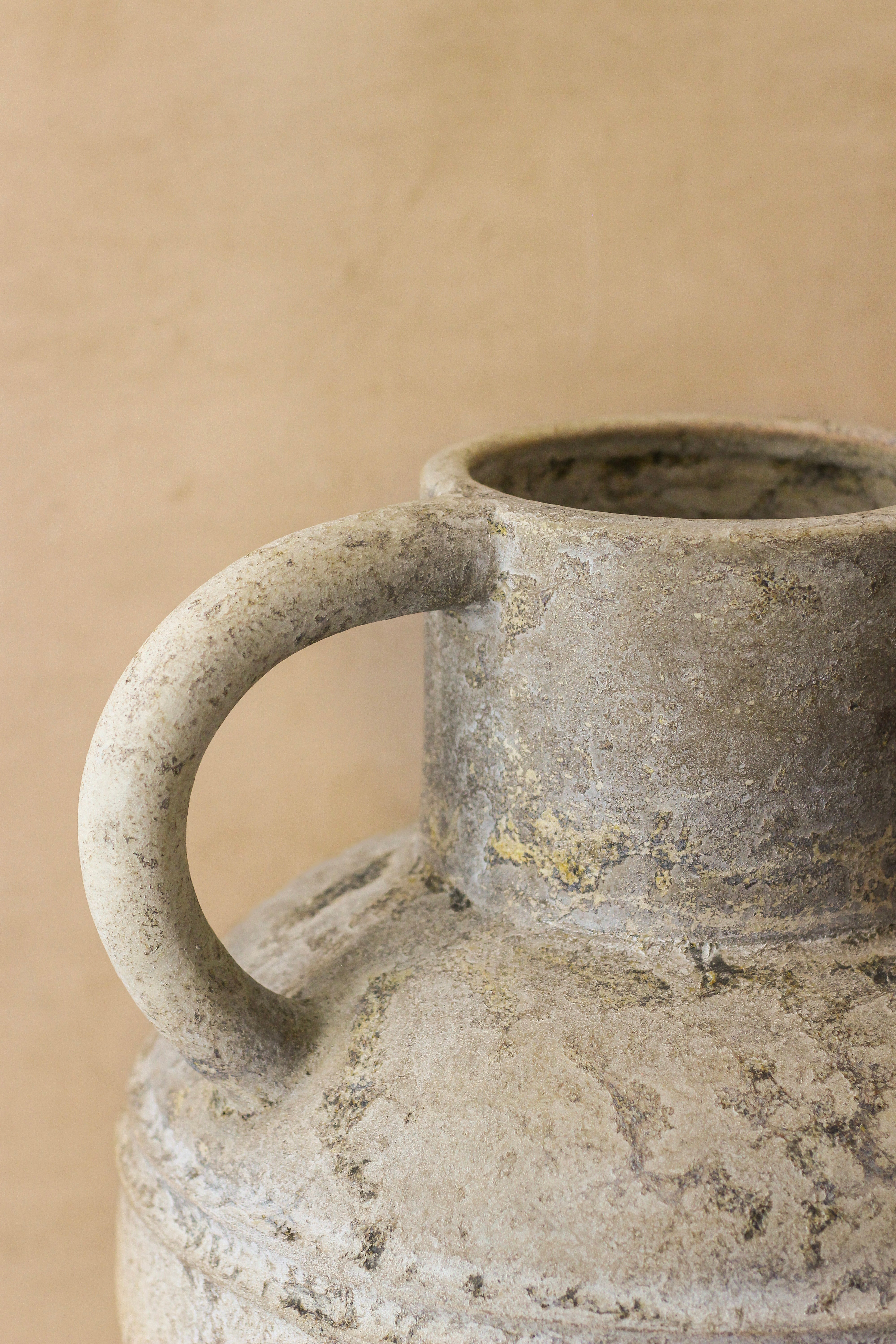 A rustic indonesian pot no 37 with a textured weathered gray ceramic body and a sturdy handle showing subtle imperfections