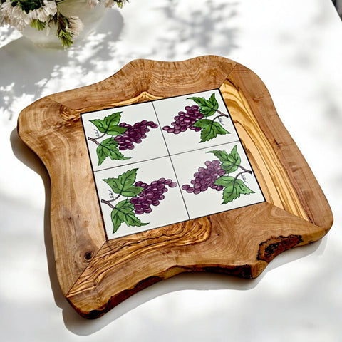 Rustic olive wood ceramic tray with handmade white tiles featuring purple grapes and green leaves for serving