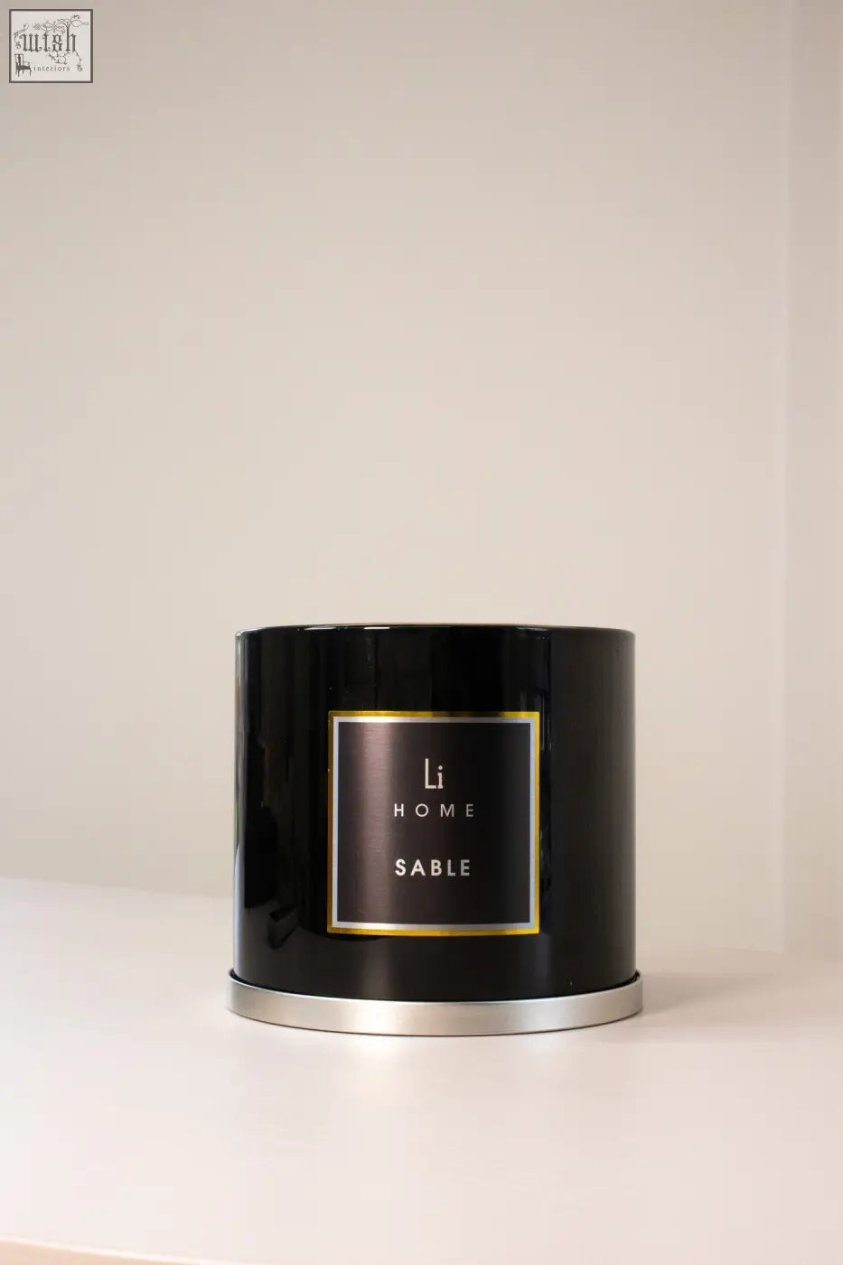 Black cylindrical 3 wick luxury candle in glossy tin with gold trimmed label from large candle collection sable