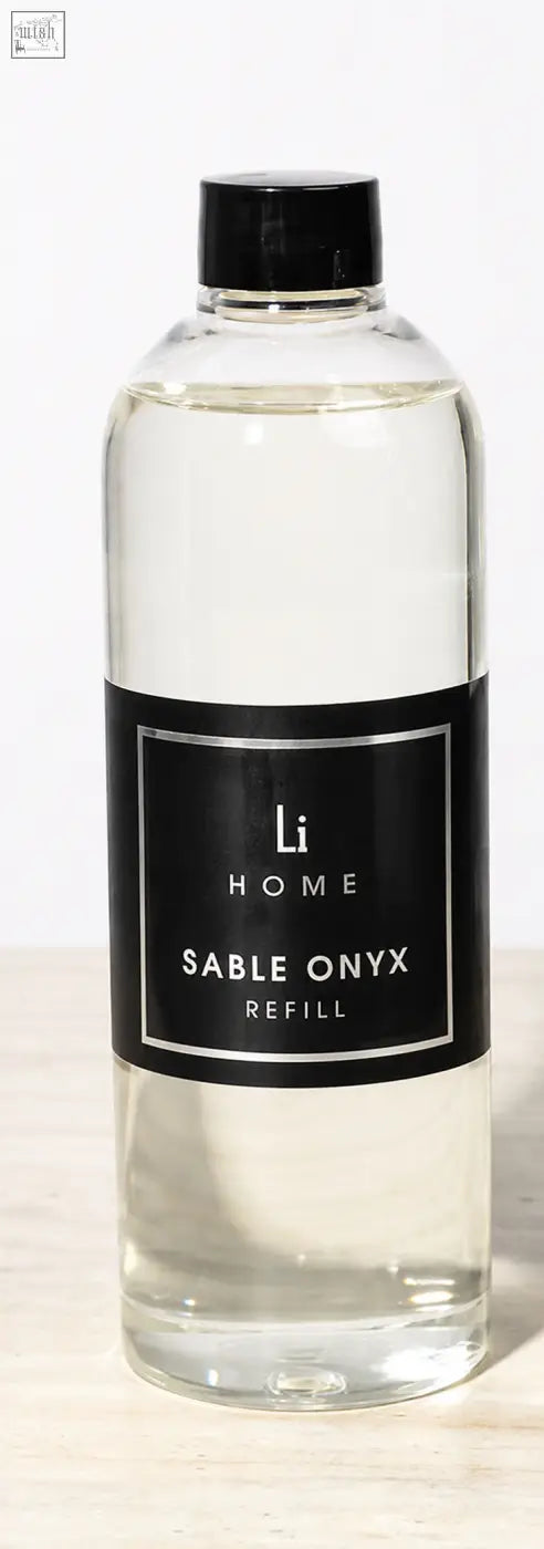 Clear glass bottle with black cap containing transparent refill for sable onyx premium xxl diffuser in lifestyle home collection