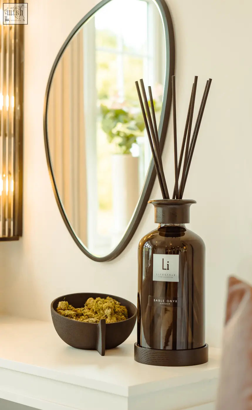Dark brown glass reed diffuser with sleek rounded bottle and slender sticks from sable onyx premium xxl home collection