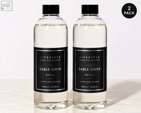 Two clear glass bottles with black caps and minimalist labels each holding 500ml premium xxl sable onyx diffuser refill
