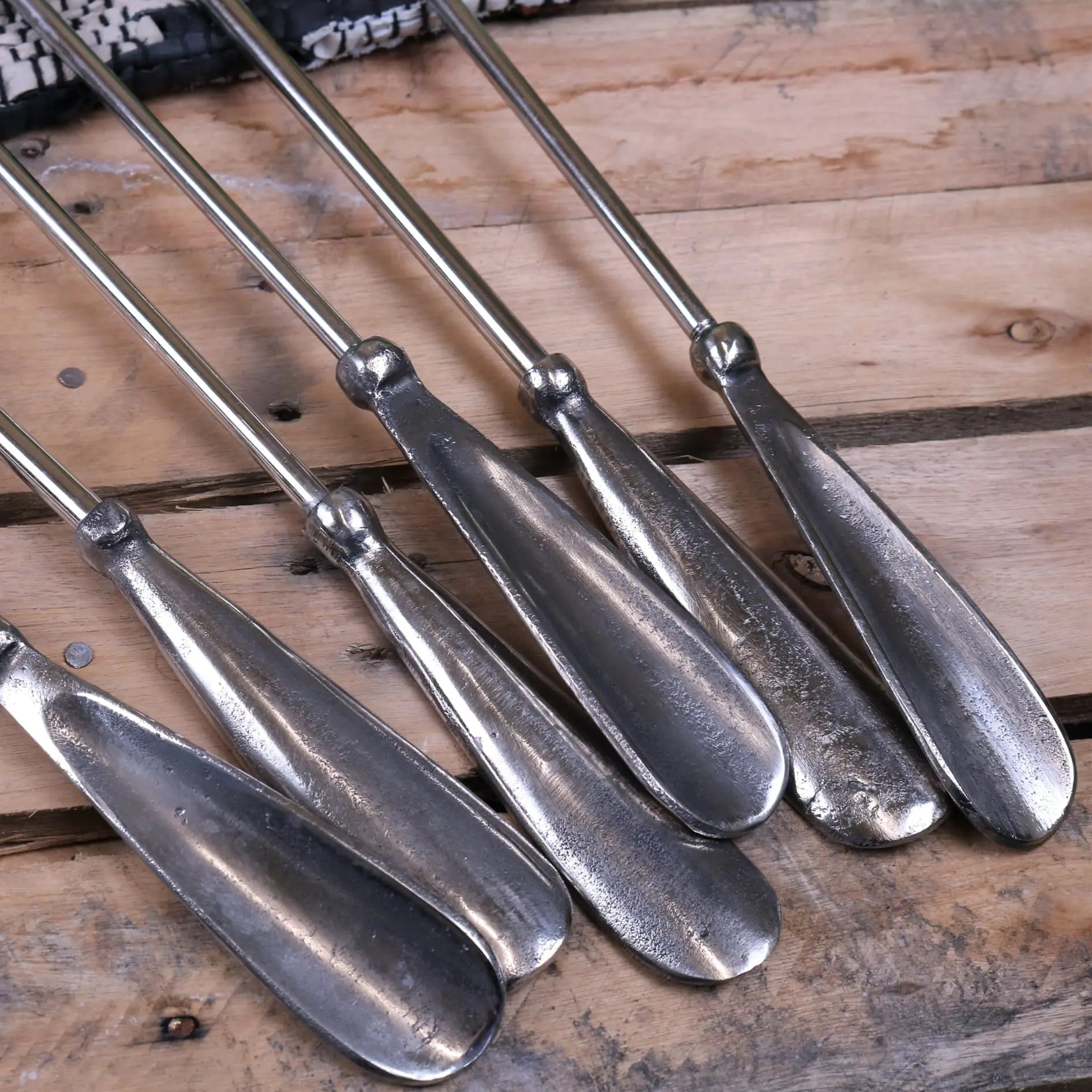 Set of five metallic shoe shine brushes with sleek elongated handles and polished silver finish for sagara long handled shoe care