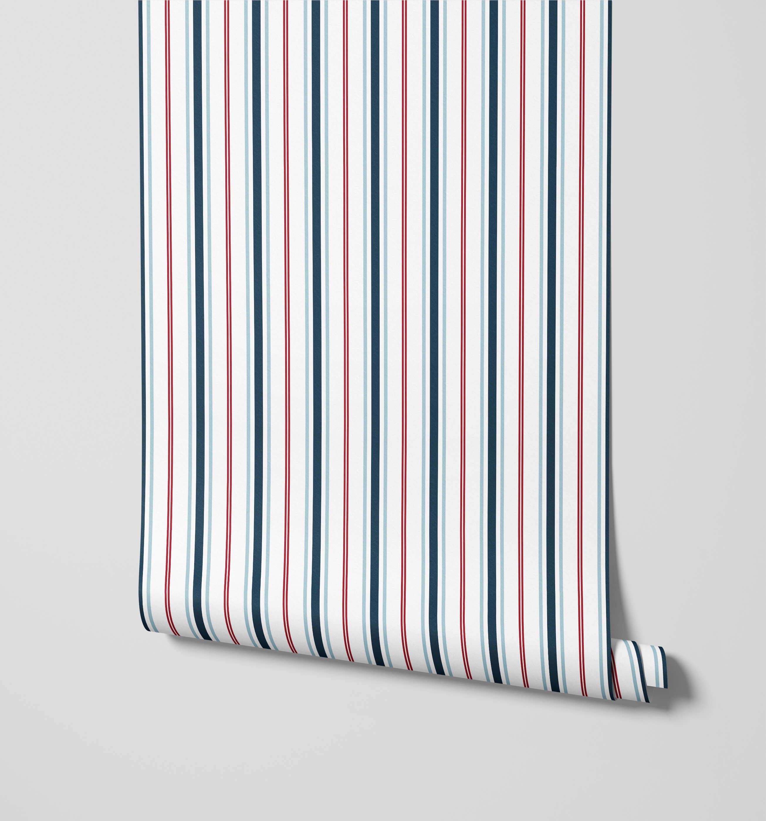A roll of sailor nautical stripe wallpaper with vertical navy blue red and white stripes for a coastal look