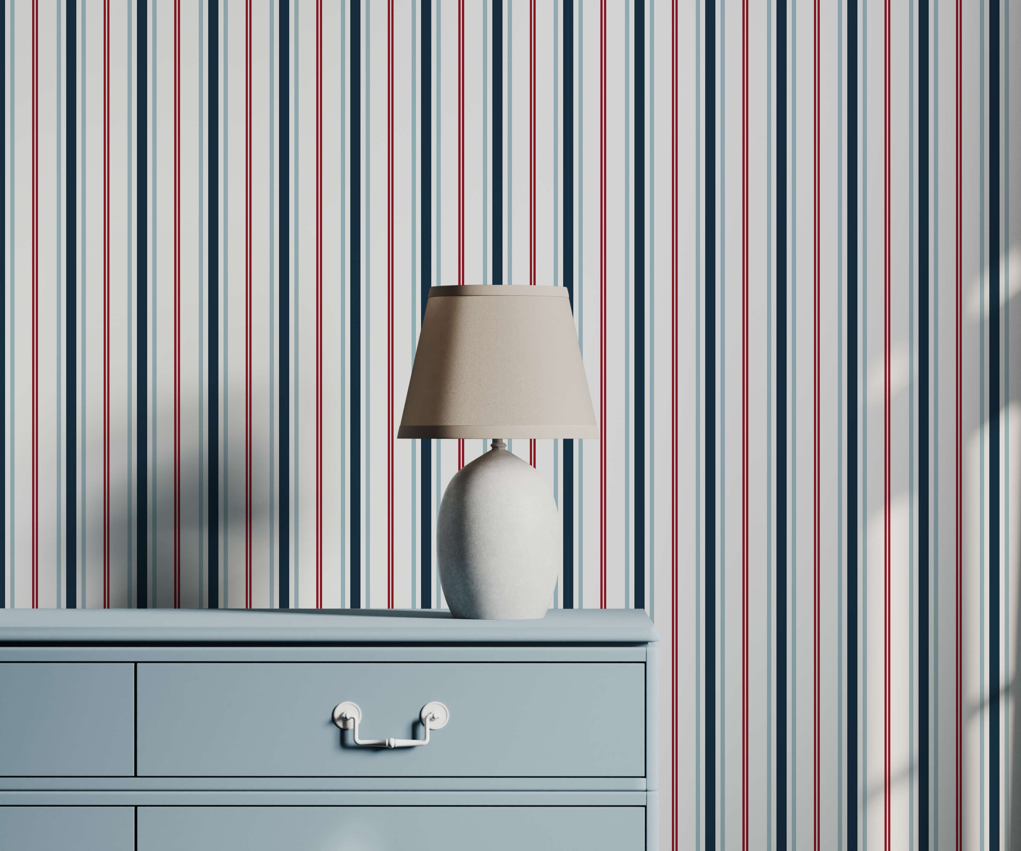 A sleek white ceramic table lamp with a beige fabric shade on a light blue dresser perfect for nautical stripe wallpaper decor