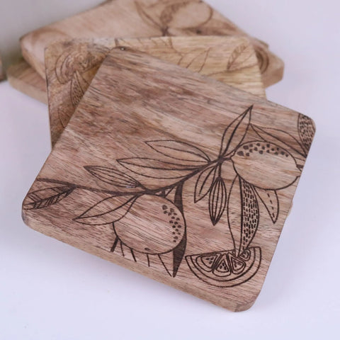 Square mango wood coasters with natural grain and dark engraved citrus design perfect for stylish drink protection