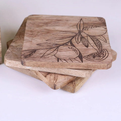 Square mango wood coasters with natural light brown finish engraved with citrus lemon and leaf designs