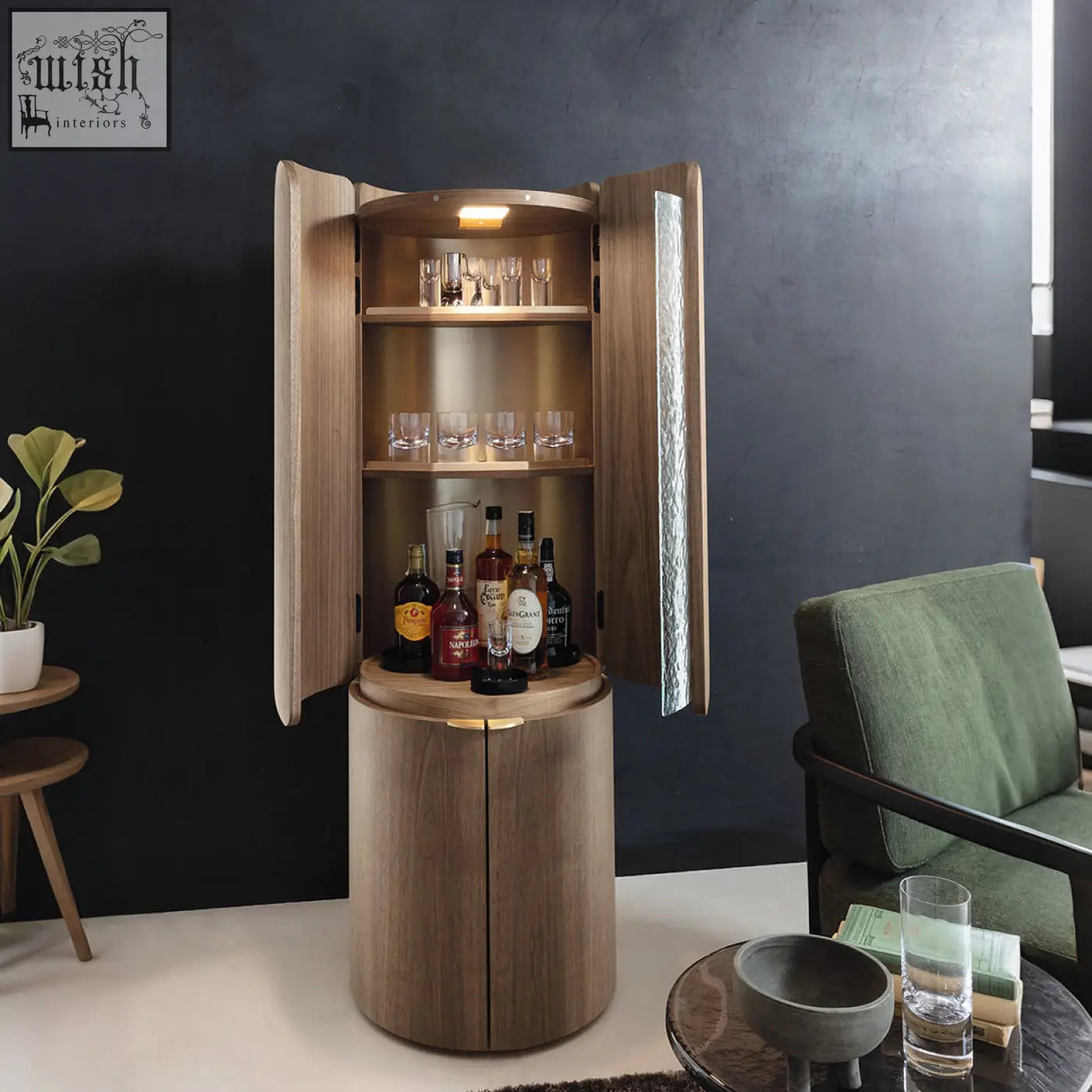 Modern round wooden sakamoto liquor cabinet with curved doors and glass shelves displaying bottles and glasses