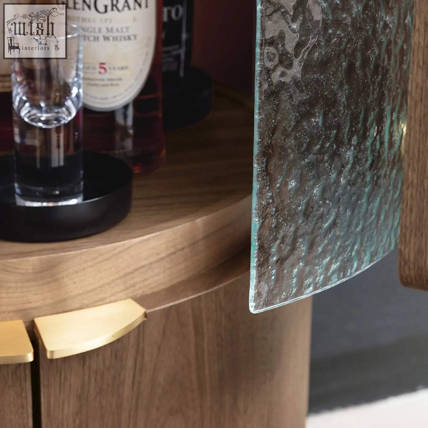 A sakamoto liquor cabinet with a textured translucent greenish blue hammered glass panel door for wine storage