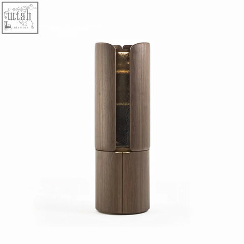 A sleek dark wood sakamoto liquor cabinet with vertical grooves and metallic gold interior for wine storage