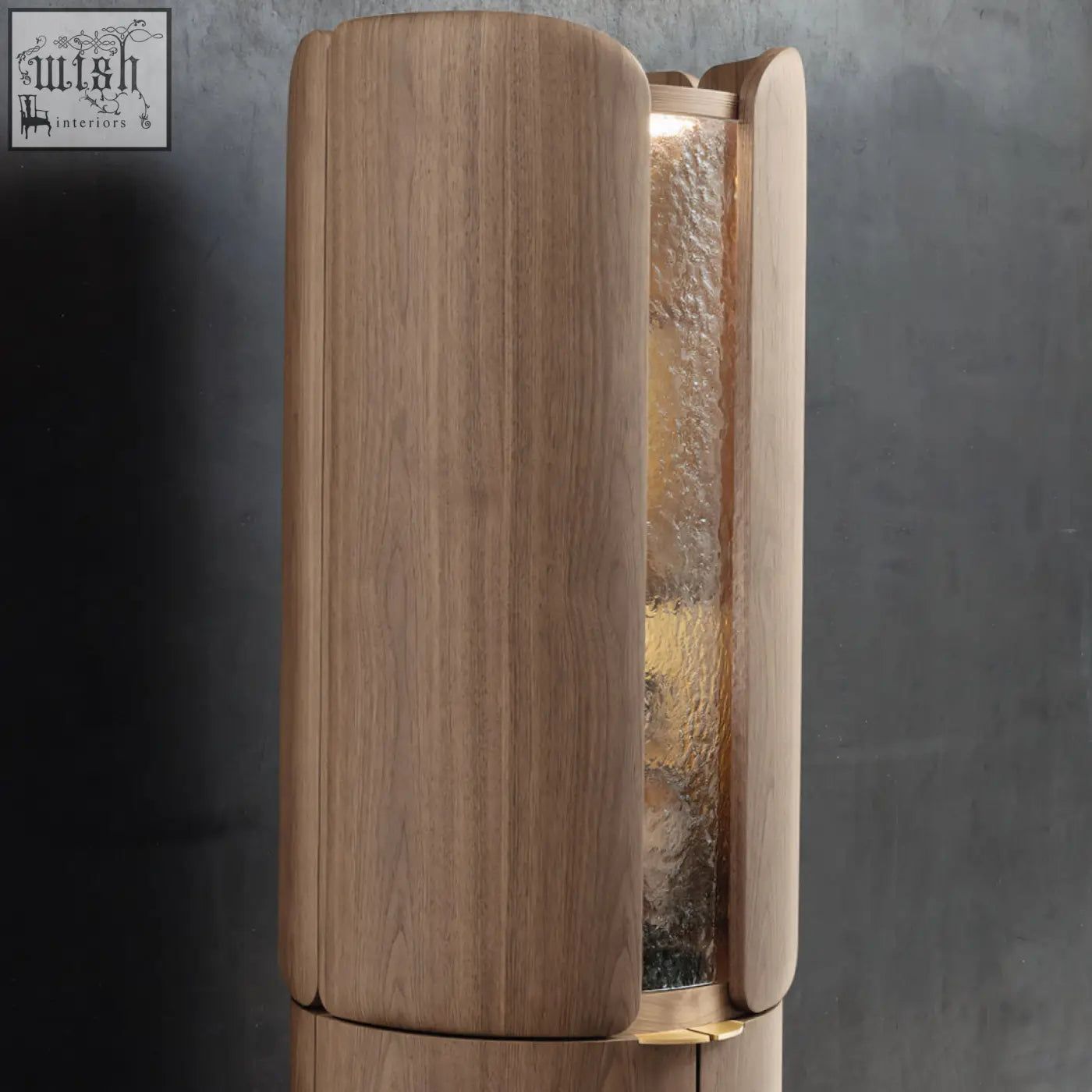 A sleek light brown wooden sakamoto liquor cabinet with textured glass panel gold hardware and two doors for wine storage