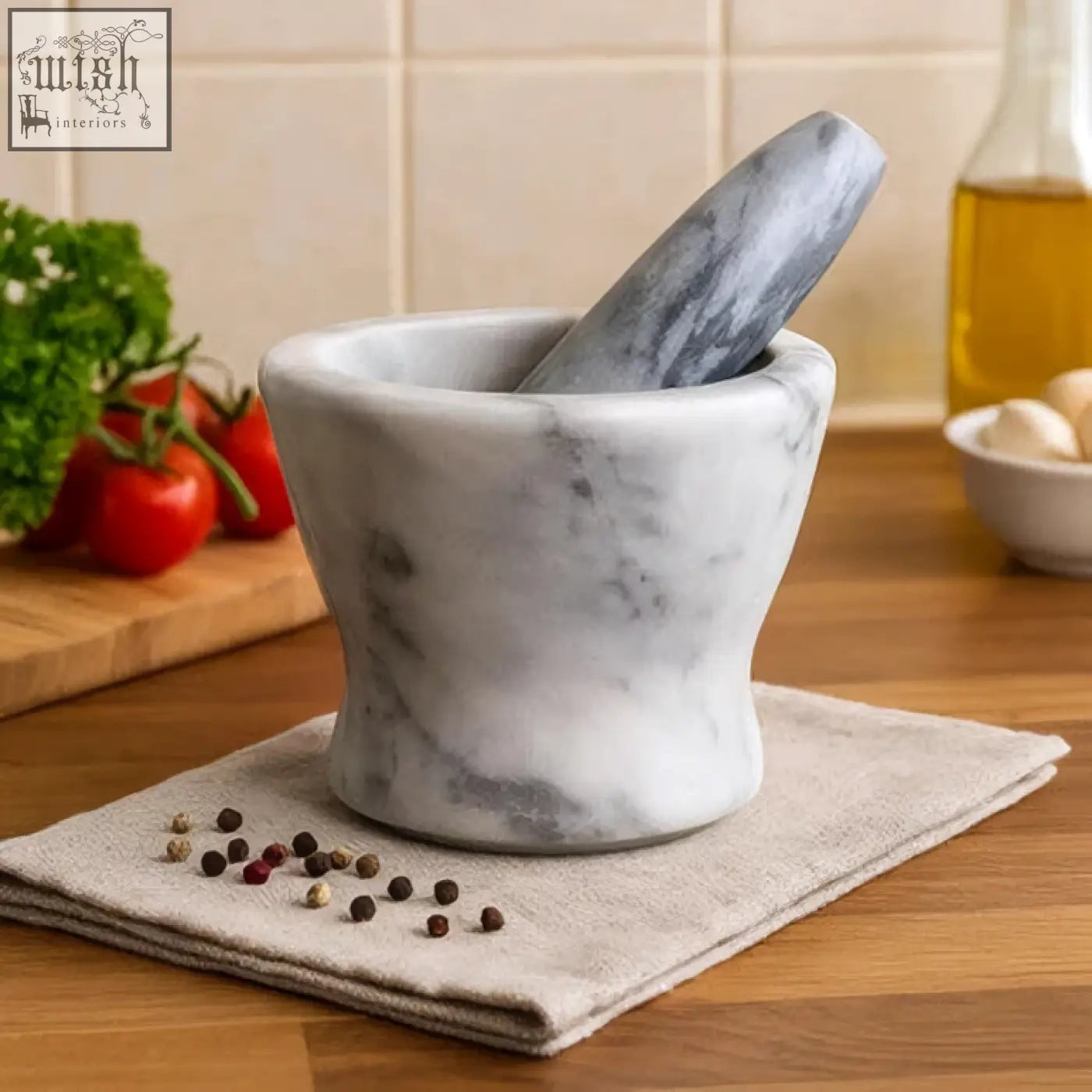 A salerno grey marble curved mortar and pestle set in white and grey marble on a light cloth background