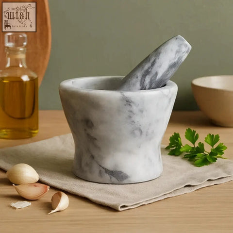 Salerno grey marble curved mortar and pestle in white and grey marble with garlic and parsley on linen cloth