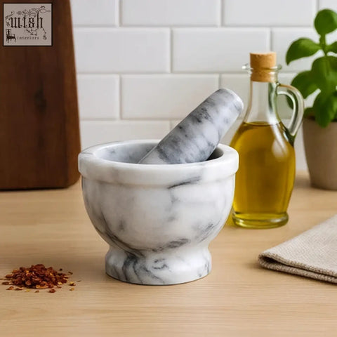 White marble salerno grey mortar and pestle with gray veining on wooden countertop perfect for grinding herbs