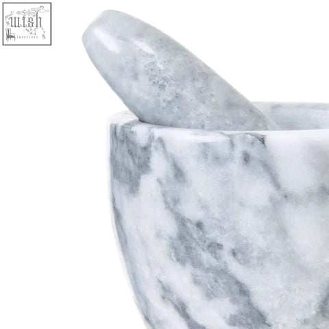 A sleek white marble tapered mortar and pestle with subtle grey marble veining perfect for grinding herbs
