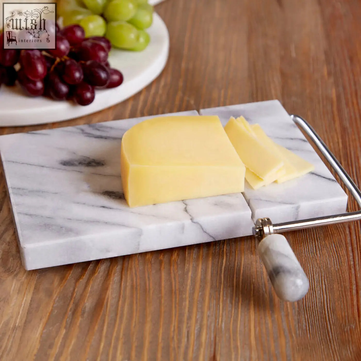 Salerno white marble cheese board with integrated metal slicer and gray veining perfect for serving cheese