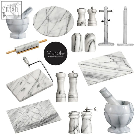 Salerno white marble cheese board with slicer shown with gray veining and kitchen tools like mortar pestle and rolling pin