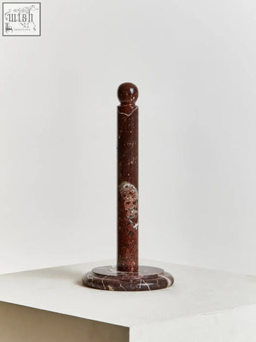 A sleek dark red marble salmo kitchen roll holder with polished finish and subtle white veining for kitchen use