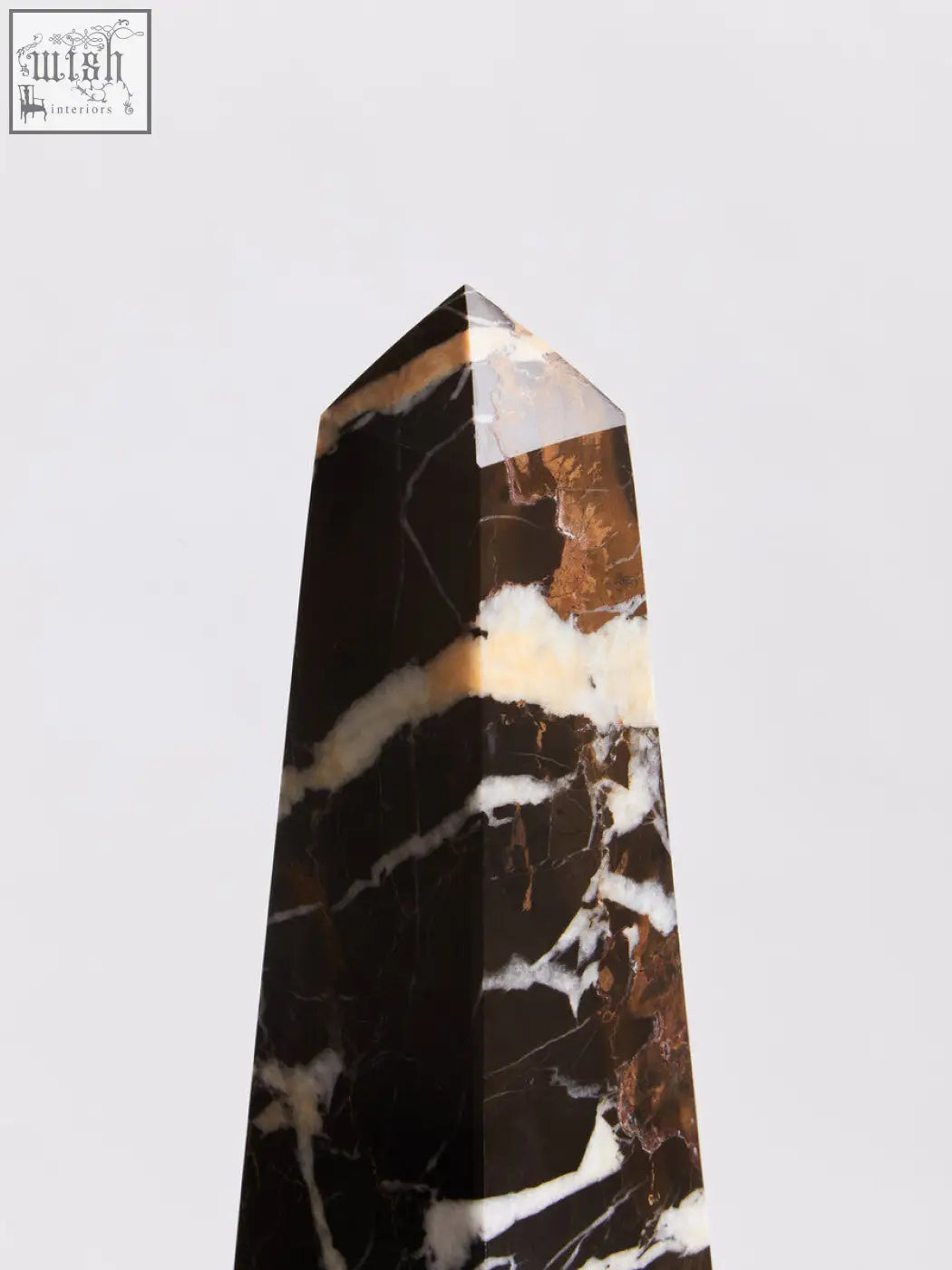 A sleek salmo large black marble obelisk with swirling white and golden-brown veining for elegant decor