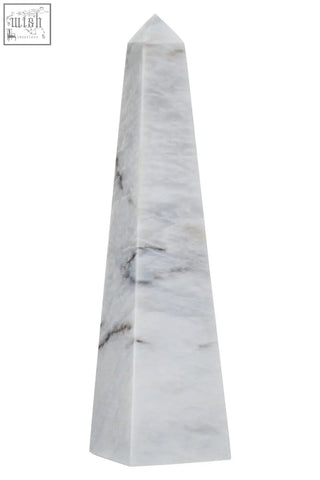 A sleek salmo large white marble obelisk with elegant gray veining and a polished smooth finish