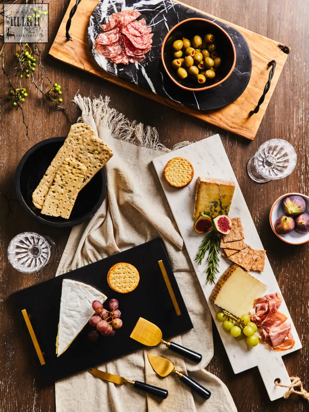 Salmo oval black marble chopping and serving board with gold handles holding brie cheese grapes and crackers