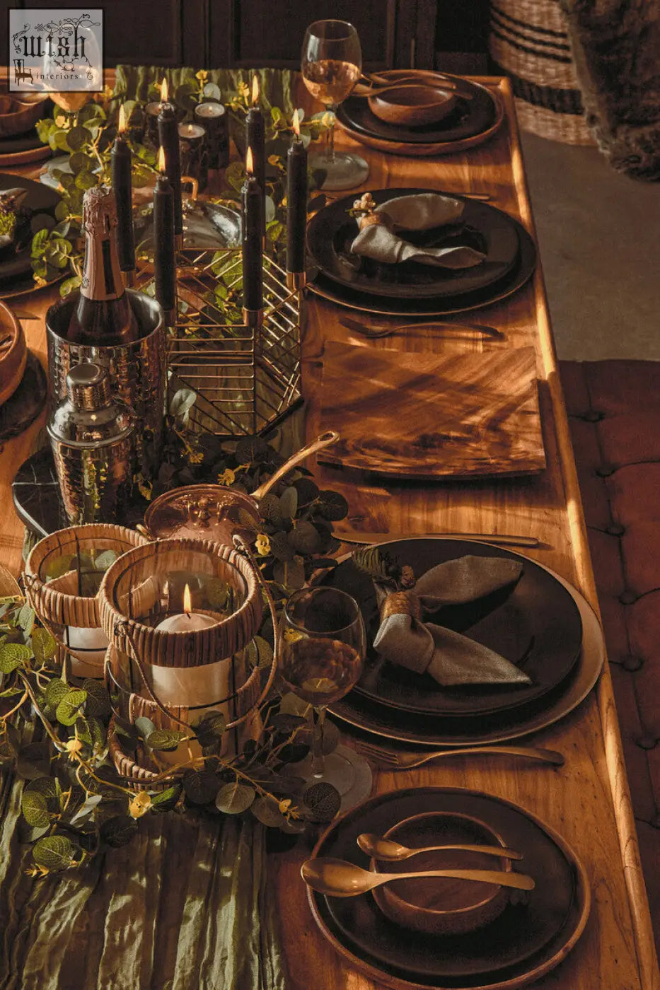 Dark matte black ceramic plates with gold rims arranged on a rustic wooden table next to salmo oval black marble chopping board