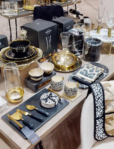 Salmo oval black marble chopping board with black and gold ceramic dinnerware and leopard print accents