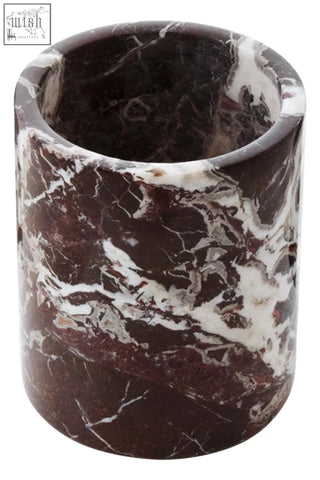 A cylindrical dark brown salmo red marble wine cooler with swirling white veining made from red marble