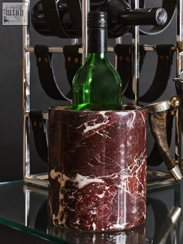 Salmo red marble wine cooler in rich burgundy marble with white veining holding a green glass bottle
