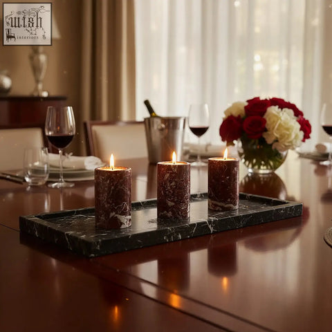 Three lit dark brown marble tealight holders on a black tray matching the salmo set of three red marble holders
