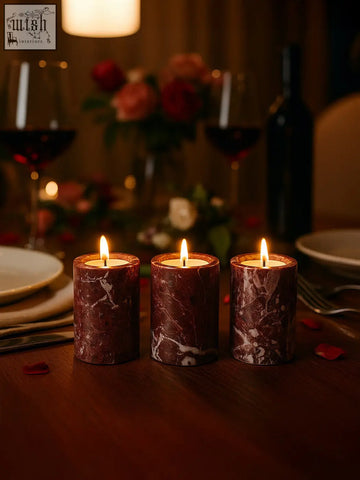 Three lit red marble tealight holders with white swirls from the salmo set of three red marble candles