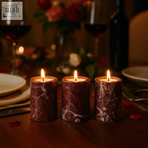 Salmo set of three red marble tealight holders with lit candles featuring white veining on a wooden table
