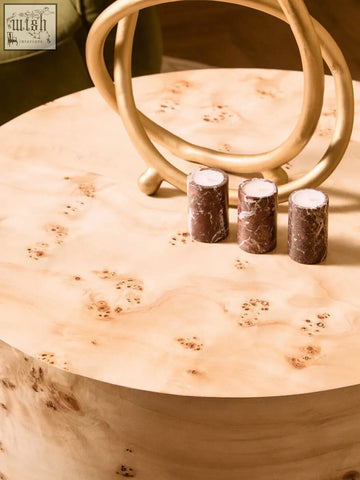 Three red marble tealight holders with dark brown veined pattern sit on light burl wood table in salmo set