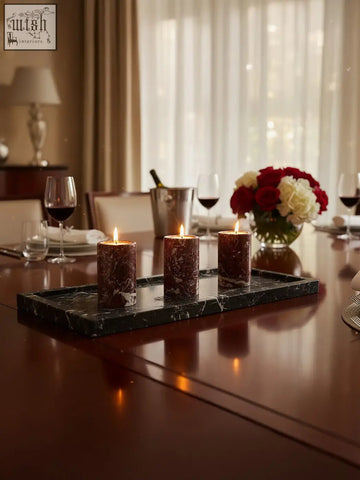Three red marble tealight holders with dark brown marble texture on a sleek black marble tray for cozy decor