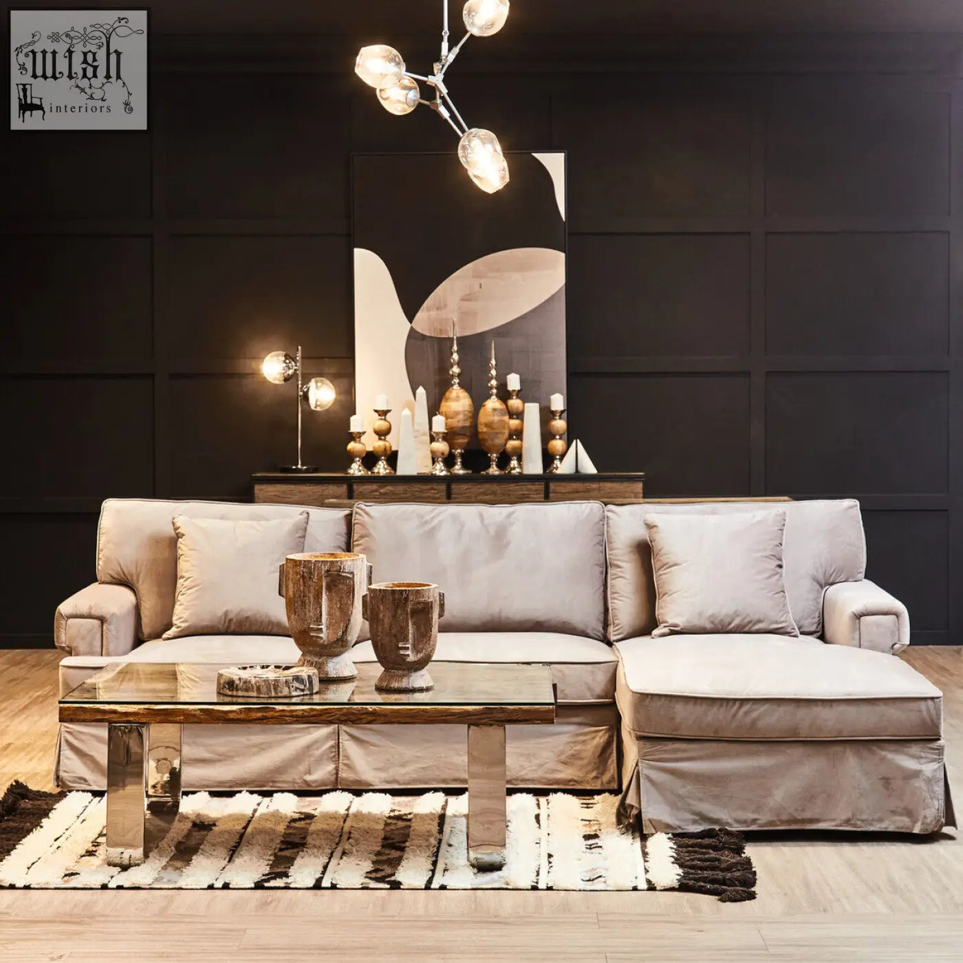 Beige slipcovered sectional sofa with chaise lounge paired with white marble bookends for modern decor