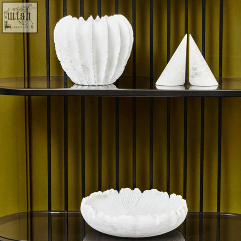 White textured ceramic vase with fluted petal ridges and scalloped rim paired with white marble bookends