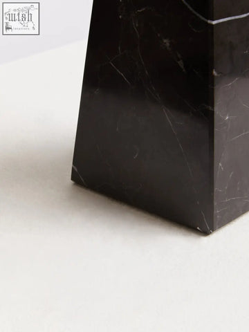 Salmo small black marble obelisk with sleek polished surfaces and subtle white veining on a small black marble pedestal