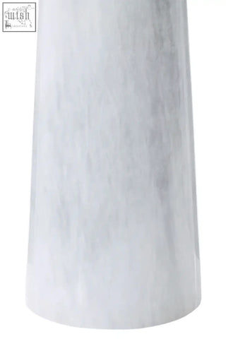 A sleek salmo white marble tapered vase with smooth polished surface and subtle gray veining on a pedestal