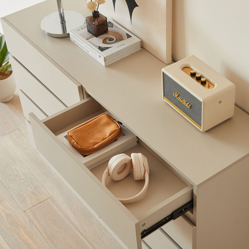 Cream-colored marshall speaker with gold accents on top of a white salome drawer cabinet with striped grille