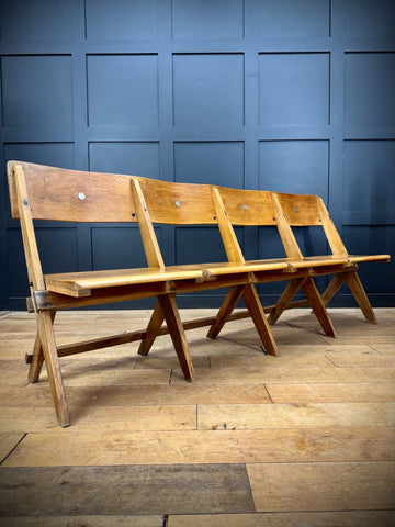 A rustic light oak wooden folding bench with metal fasteners from salvaged antique oak church chairs for hallway seating