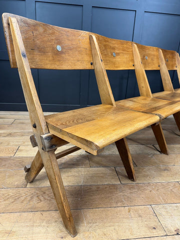 Rustic light oak church bench with slatted back and angled legs from salvaged antique oak church chairs collection