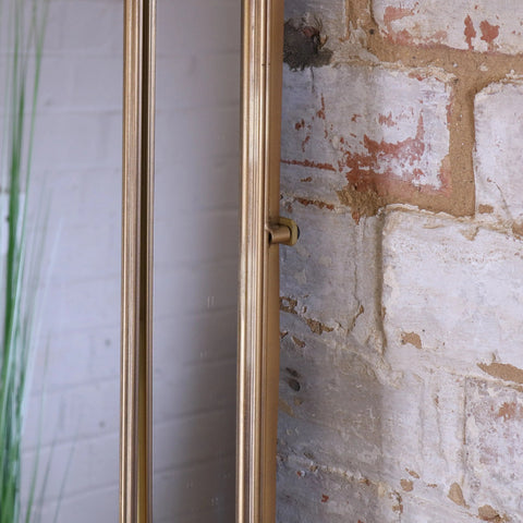 Samela full length arch mirror with gold frame and brushed brass hardware featuring a sleek modern arch design