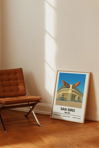 A framed san siro exterior stadium print with bold black text on white and a vibrant blue sky background