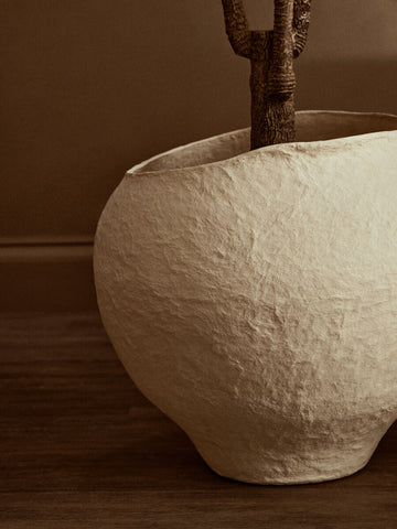 Cream-colored large beige planter made of textured ceramic with a rustic handcrafted look sanai cotton mache large beige planter