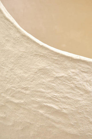 A smooth curved shoreline inspires the beige color of the sanai cotton mache large beige planter perfect for decor